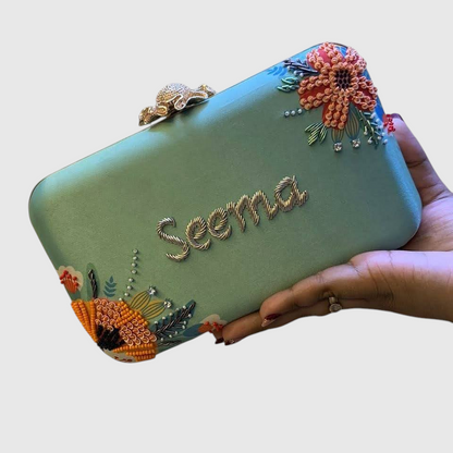Cannish Pitara personalized mint green clutch with hand-embroidered floral details and custom name Seema