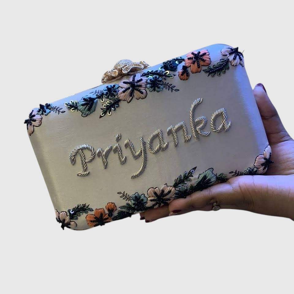 Cannish Pitara personalized clutch with Priyanka name embroidery, floral handwork, and metallic clasp.