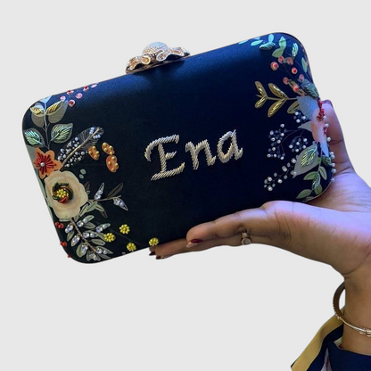 Cannish Pitara personalized navy blue clutch with hand-embroidered floral details and custom name Ena in metallic thread