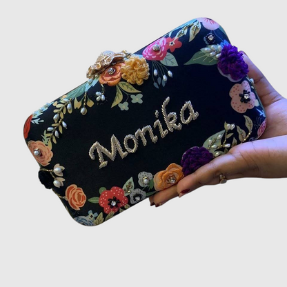 Cannish Pitara personalized black clutch with floral embroidery and custom name Monika in gold thread